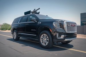 Civilian armored SUV with mini gun mounted on top