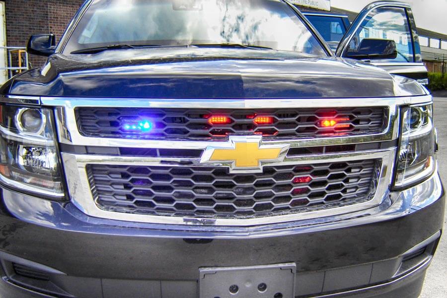 TAG Emergency lighting system on a black armored Chevrolet Suburban 1500