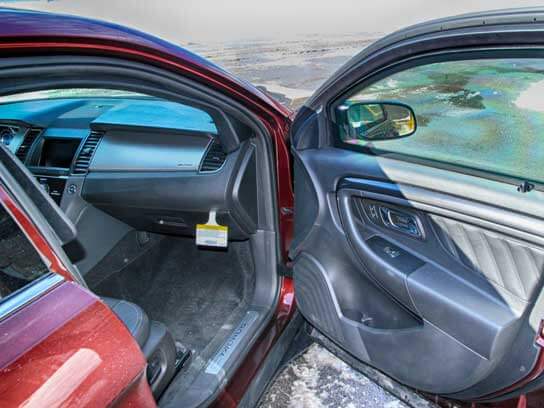 TAG Interior of red armored Ford Taurus with bulletproof glass and reinforced door hinges