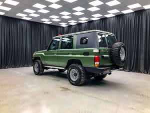 Green armored SUV indoors