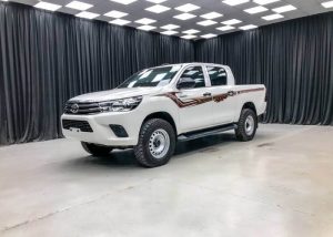 Side profile view of white armored toyota hilux