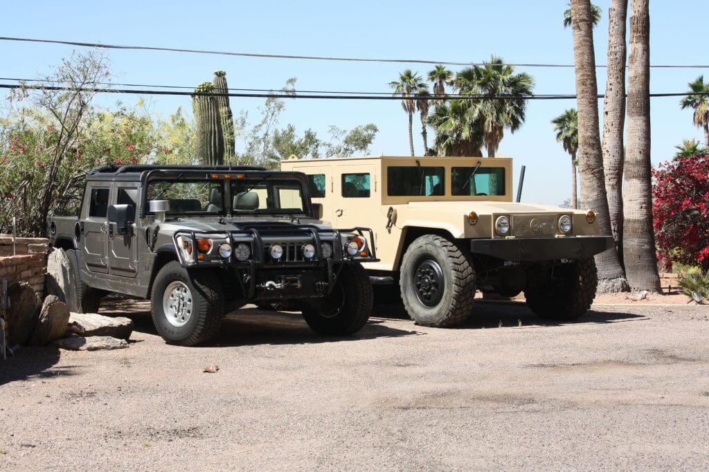 TAG Armored Hummer Front Corner Side View Multiple Hummers Outdoors