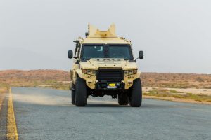 Armored military vehicle driving in the desert