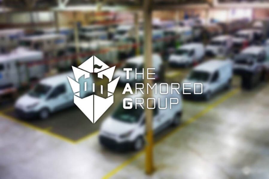 The Armored Group Featured Image Logo Over Blurry Warehouse Background