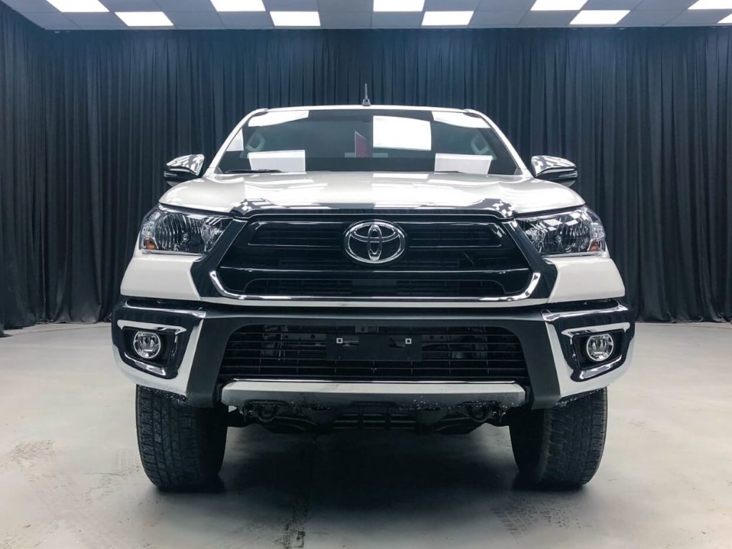 Front view of white armored Toyota Hilux
