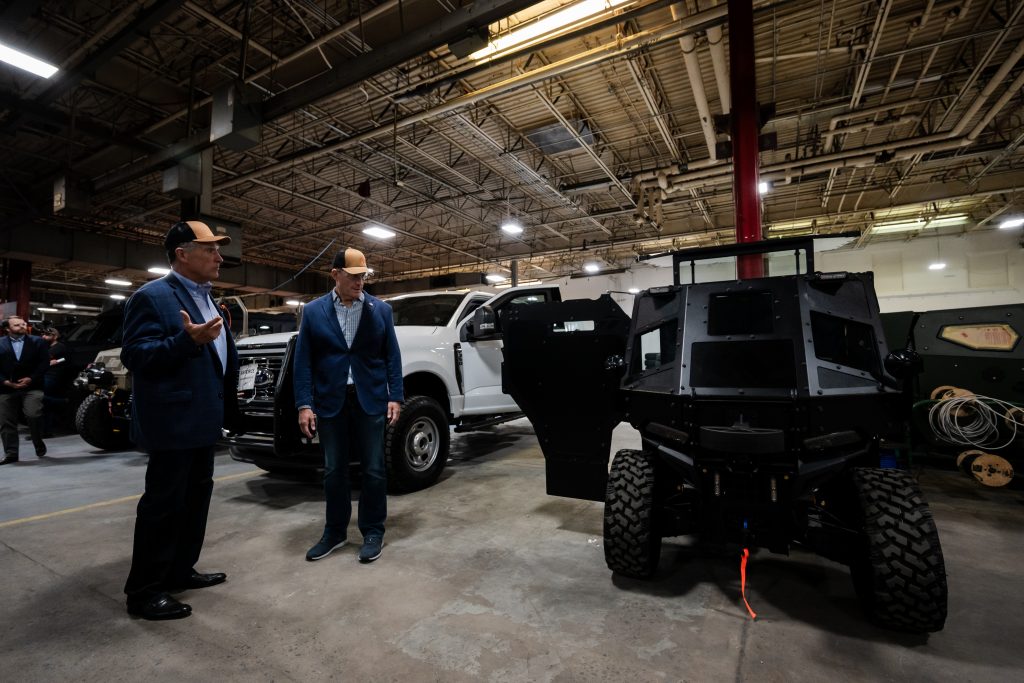 Senator Budd in front of an armored car